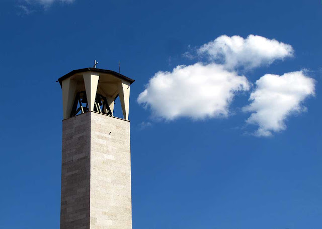 Clouds like puffs of smoke, bell tower of the church of Nostra Signora del Rosario, Livorno