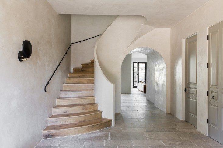 The stairs in this Spanish villa with interior design by Leigh Herzig are solid white oak that Herzig had carefully matched to the wood flooring. COME SEE MORE Rustic Spanish Villa Interior Design Inspiration!