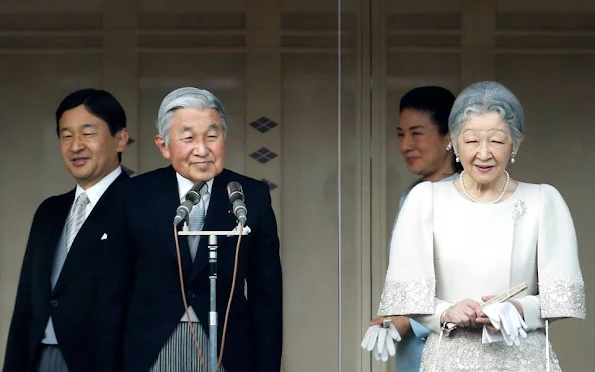 Members of the Imperial family wave to well-wishers during the celebration for the New Year on the veranda of the Imperial Palace