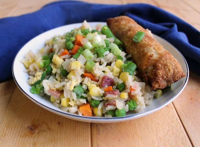 Make pork fried rice without leftover rice. This simplified recipe comes together quickly, tastes great and starts with uncooked white rice! bowl of fried rice with an egg roll