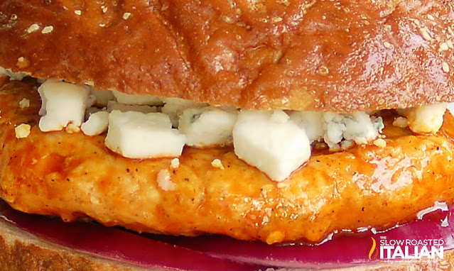 extreme closeup of white crumbled cheese on top of grilled sandwich