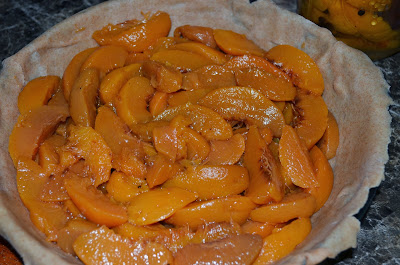 Layers of spiced peaches in the pie pan Photo by Trisha Field