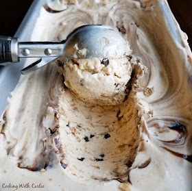 Super simple no churn ice cream sweetened with the goodness of dulce de leche and studded with bits of sugar cones, mini chocolate chips and a chocolate swirl. Make your sundae dreams come true with every bite! scooping out a ball of ice cream with chocolate ribbon
