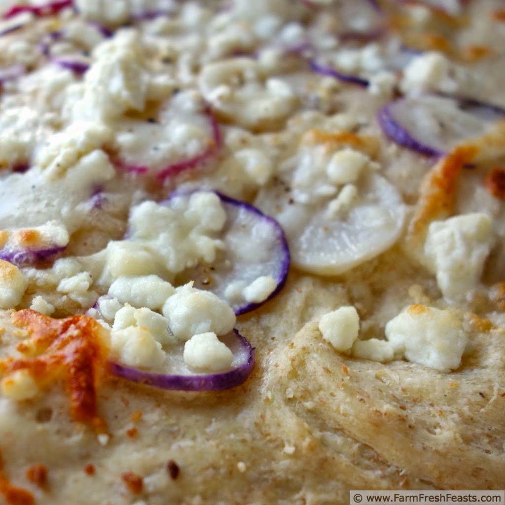 Thinly sliced radishes with feta, goat cheese, and shredded cheeses in a spring radish pizza.