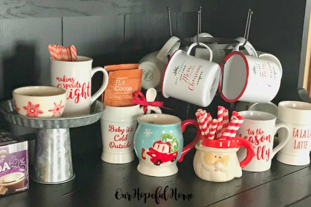 Gather up your Christmas mug collection for a festive cocoa bar display making spirits bright mug tis the season to be jolly mug fa la la la latte mug
