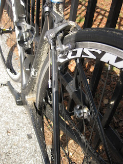 Dried mud coats the seat tube, rear brake, and chainstays.