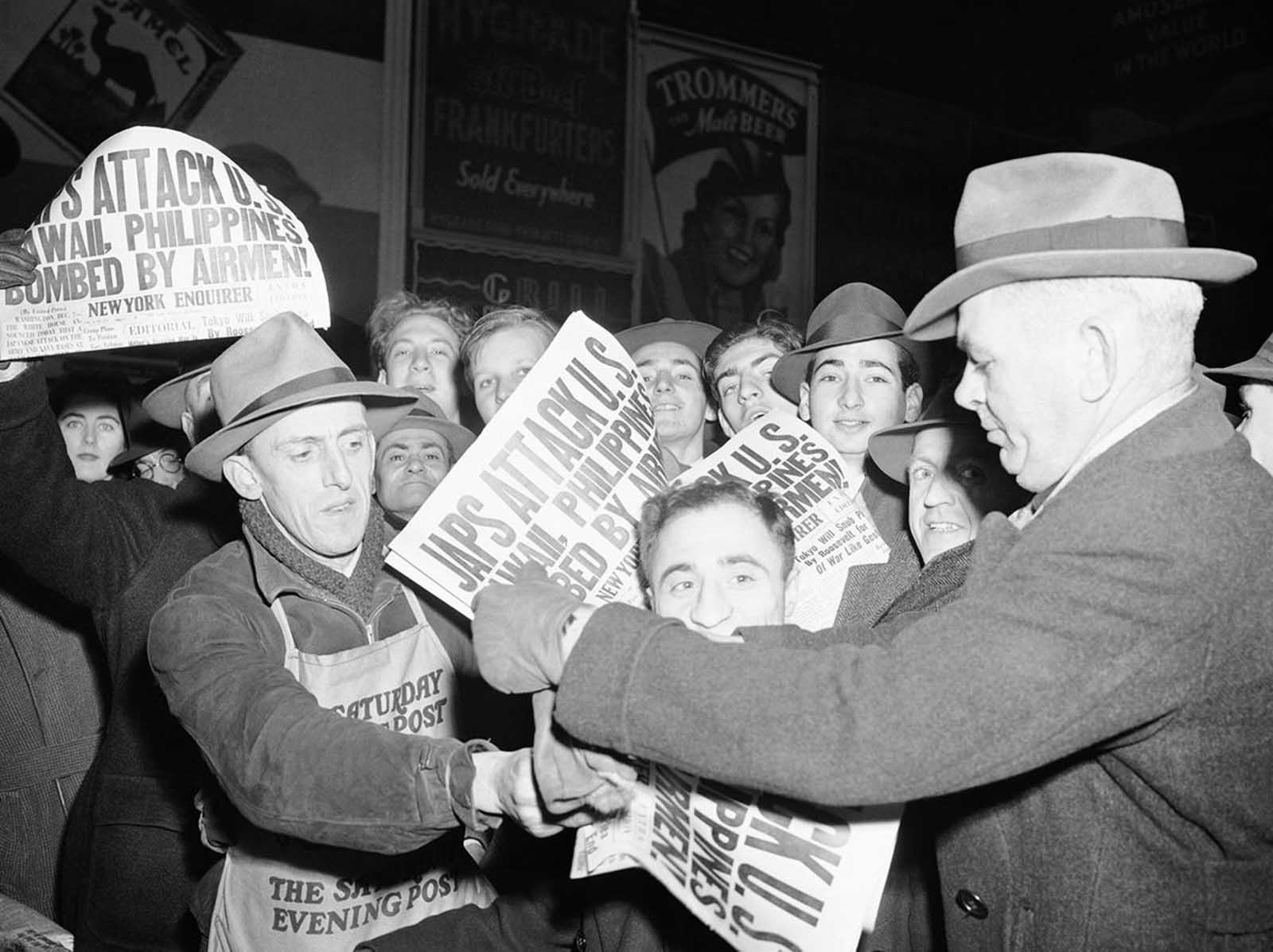 Selling papers on December 7, 1941 at Times Square in New York City, announcing that Japan has attacked U.S. bases in the Pacific.