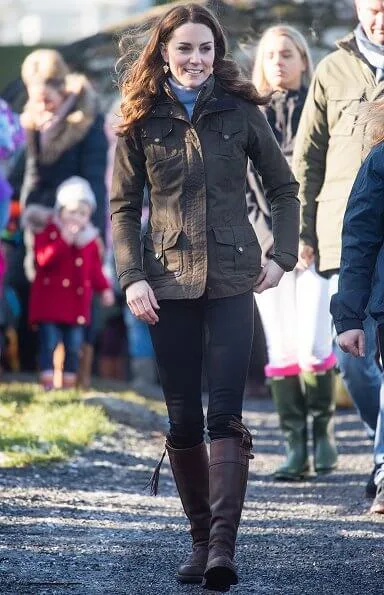 Kate Middleton wore a gray knit turtleneck, black skinny jeans, a khaki Barbour jacket, and knee-high Penelope Chilver boots