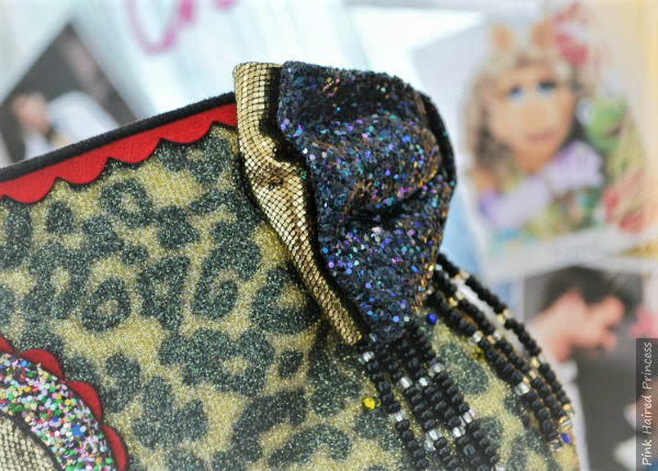 glitter bow detail from the side in bronze metallic and black glitter layered glitter and metallic bows on back of ankle boot from side