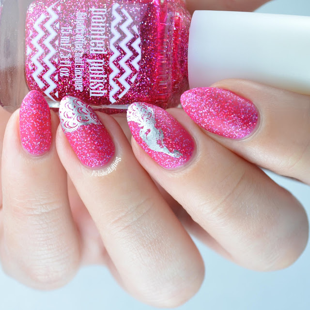 Matte pink nail polish with peacock stamping