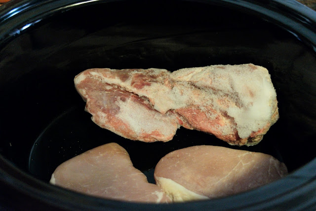 The frozen pork chops in the slow cooker. 