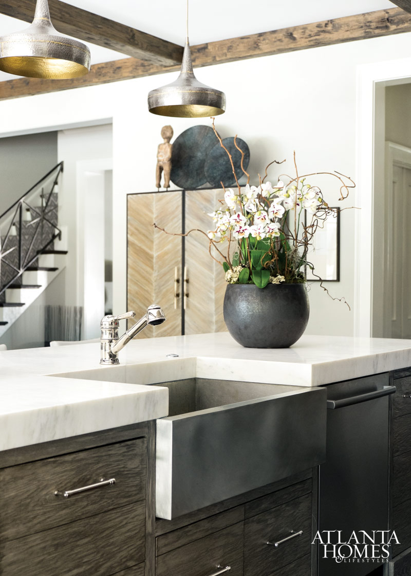 Modern eclectic kitchen with extra thick stone on island and farm sink