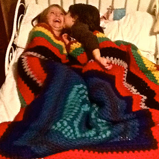 Niñas duermen con la manta de abuela hecha a ganchillo
