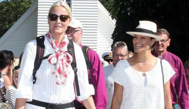 Crown Princess Mette-Marit down the path to the water where she fills a small bottle with water from Elgåfossen