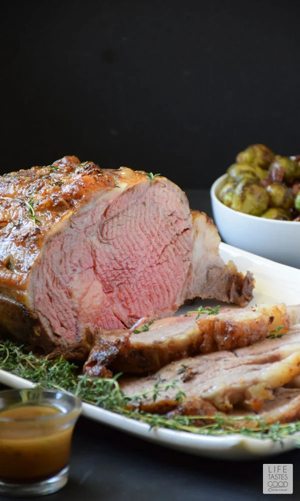 Garlic Crusted Prime Rib Roast | by Life Tastes Good with a buttery soft texture on the inside and a crisp garlicky outside melts in your mouth like a luscious piece of chocolate! I just want to savor the glorious flavor as long as possible. It tastes so good and is exactly why I always serve my Garlic Crusted Prime Rib Roast for our Christmas dinner. #LTGrecipes #SundaySupper #RoastPerfect