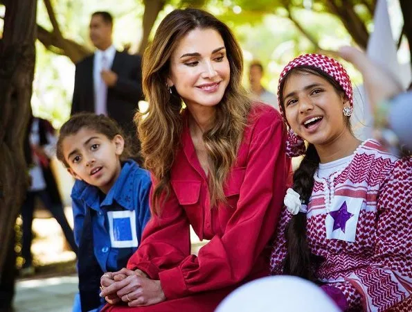 Queen Rania of Jordan visited Masahati Carnival organized by Madrasati initiative at Millennium Park in Amman. Queen wore red vintage belted shirt dress