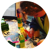 builder tuff tray with duplo bricks, diggers, shaving foam cement and a trowel