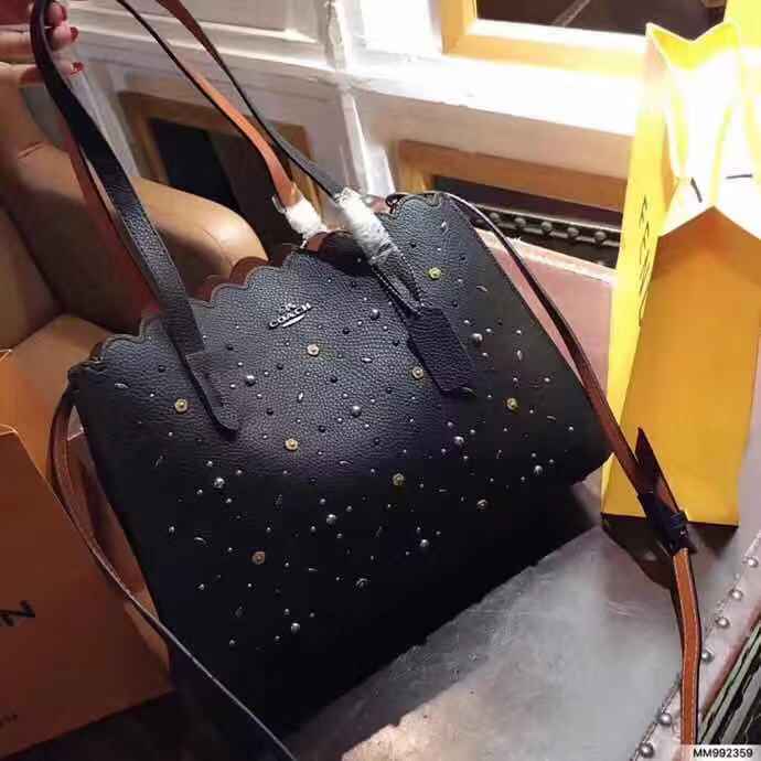 coach charlie carryall with rivets