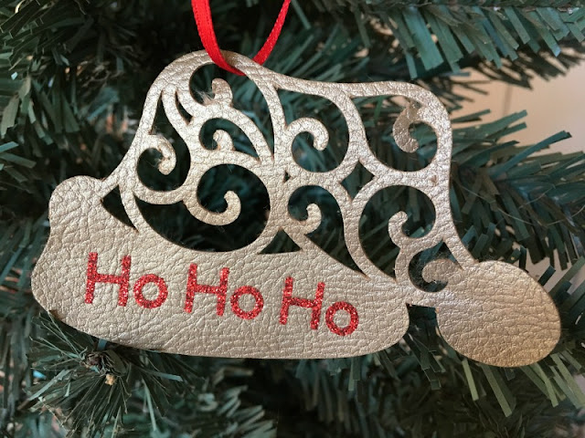  I used my Cricut to make a Santa hat Christmas ornament using faux leather and glitter iron on vinyl.