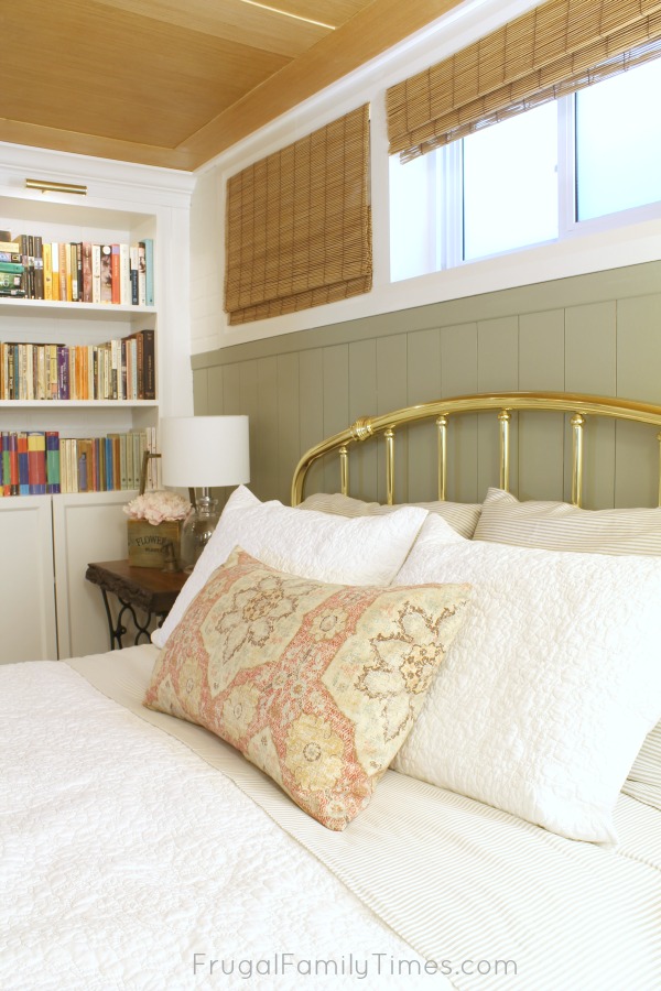 How to add vertical shiplap paneling in a way that's both easy and affordable! This sage green painted, vertical panelling was created on a tiny budget - less than $25 including the paint! (Behr's Milk Thistle) Basement bedroom: basement window covering, antique treadle sewing table, and more #decor #budgetdecor #bedroomideas #basement #farmhouse #cottage #frugalfamilytimes vertical shiplap diy