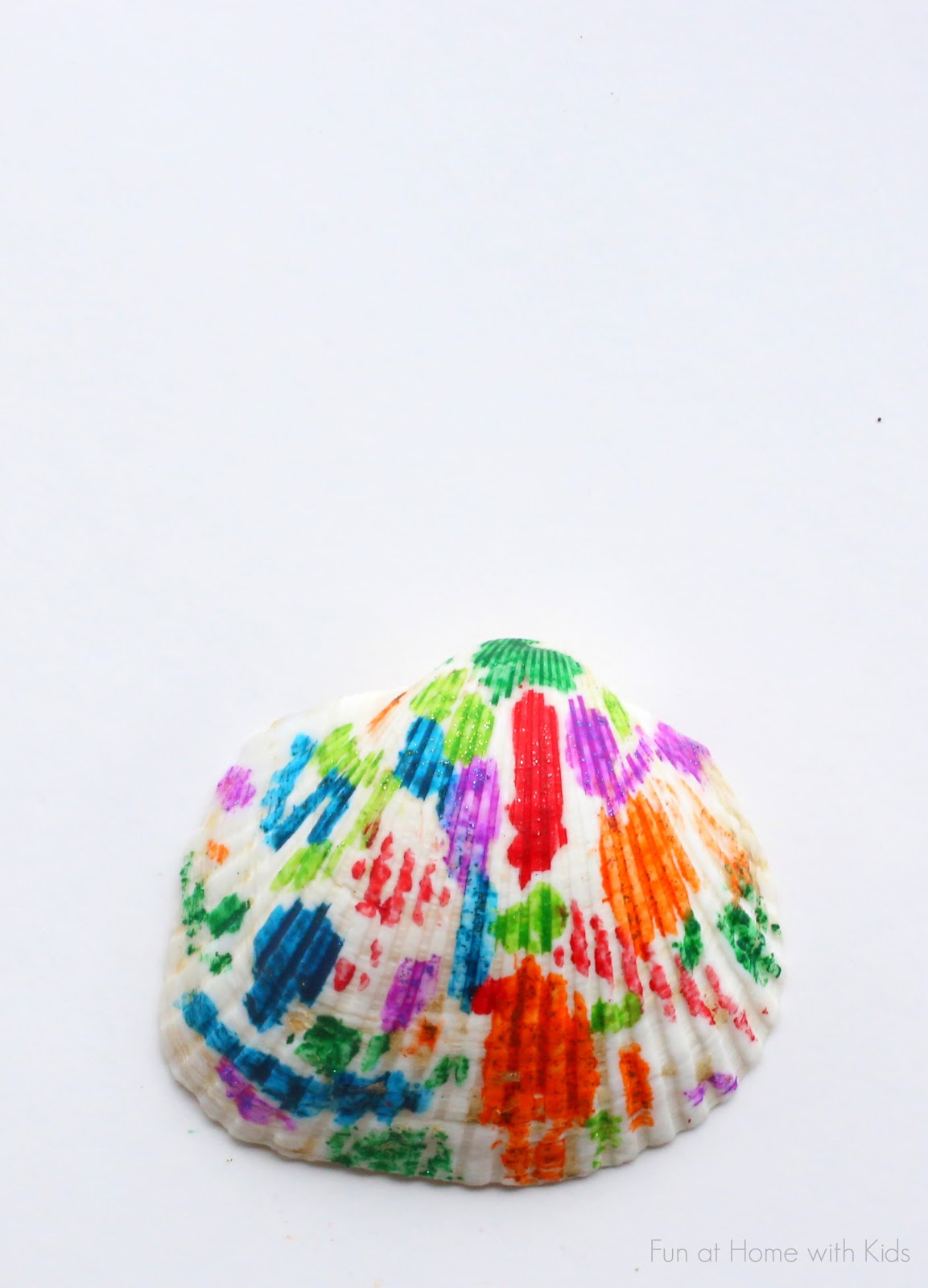 Make beautiful rainbow Melted Crayon Seashells out of shells from the Dollar Tree!