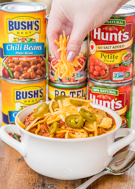 Slow Cooker Pulled Pork Chili - our all-time favorite chili! Pulled pork, Bush's chili beans, Hunt's Petite diced tomatoes, Hunt's tomato sauce, Ro*tel diced tomatoes and green chilies, chili seasoning, minced onion, and tomato juice. Just dump everything in the slow cooker and let it work its magic! Makes a ton - great for tailgating, potluck, holiday get-togethers. Can freeze leftovers for a quick meal later! LOVE this chili!!! #ad #WMChiliPride #slowcooker #chilirecipe Slow Cooker Pulled Pork Chili - our all-time favorite chili! Pulled pork, Bush's chili beans, Hunt's Petite diced tomatoes, Hunt's tomato sauce, Ro*tel diced tomatoes and green chilies, chili seasoning, minced onion, and tomato juice. Just dump everything in the slow cooker and let it work its magic! Makes a ton - great for tailgating, potluck, holiday get-togethers. Can freeze leftovers for a quick meal later! LOVE this chili!!! #ad #WMChiliPride #slowcooker #chilirecipe