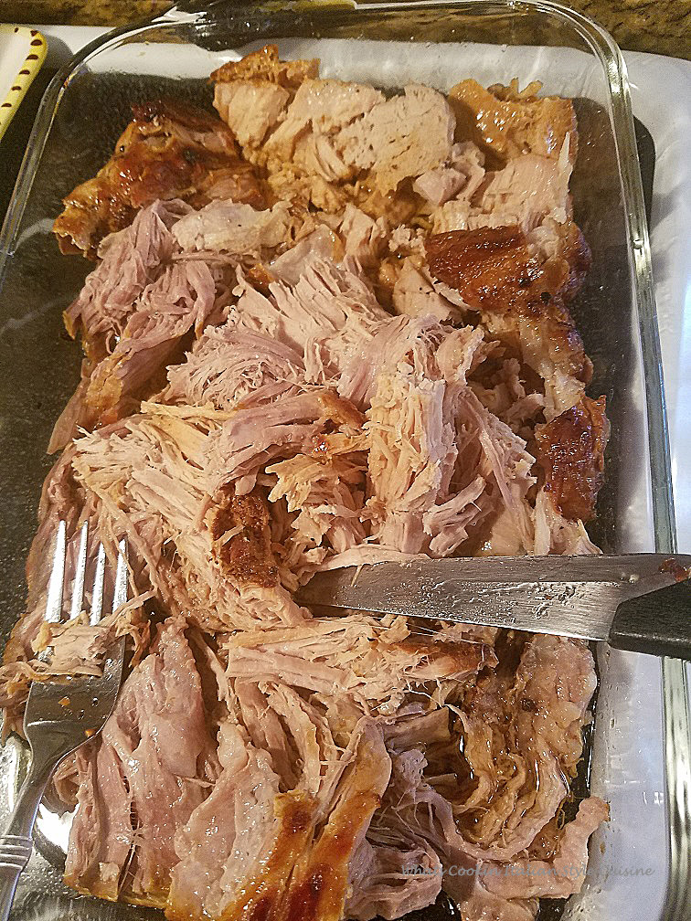 Smoked oven roasted pulled pork in juices, spices and cooked until tender slowly cooked. This smoked pulled pork  was cooked in a dutch oven and in a glass dish for serving purposes. Two forks shreds the pork perfectly or slicing it with a sharp knife