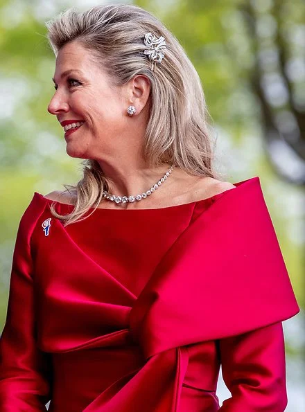 Queen Maxima wore a red top and red trousers. by Natan.Sarah's clutch bag. Carré Royal Theatre and around Amstel River