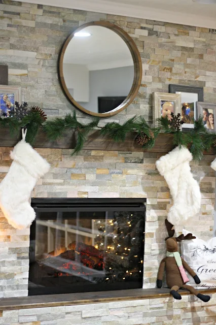 stone fireplace with wood hearth and mantel