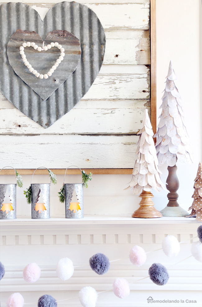 corrugated metal heart wall art and paper cone tree on mantel display