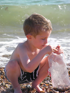 filling a plastic bottle with stones