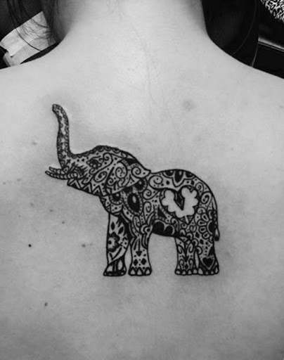 Outro exemplo de um elefante coberto em um padrão de mandala é visto no centro do utente está de volta neste tatuagem.