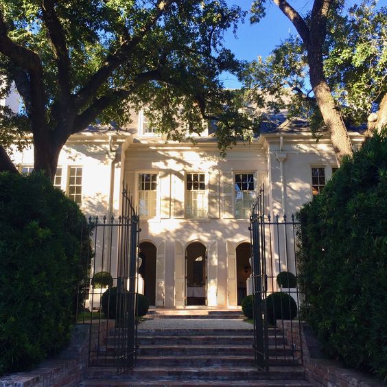 Pamela Pierce's white home exterior and arched French doors in Houston.