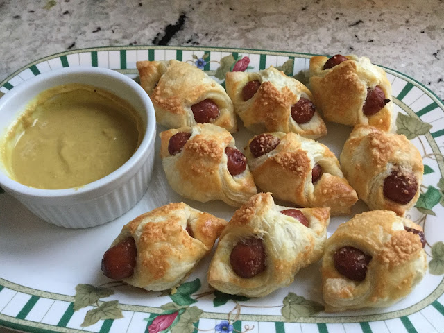 Serve a tray of Parmesan crusted pigs-in-a-blanket at your next party and watch them disappear. Pigs-in-a-blanket served with honey mustard