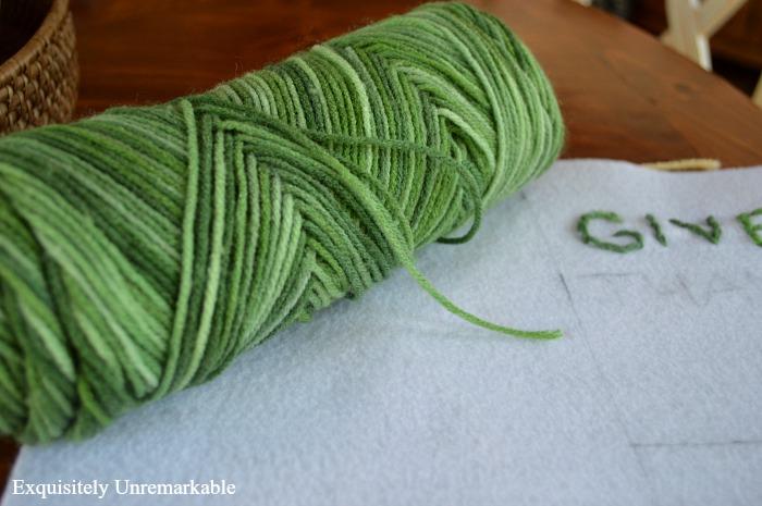 variegated yarn skein and felt pattern on table
