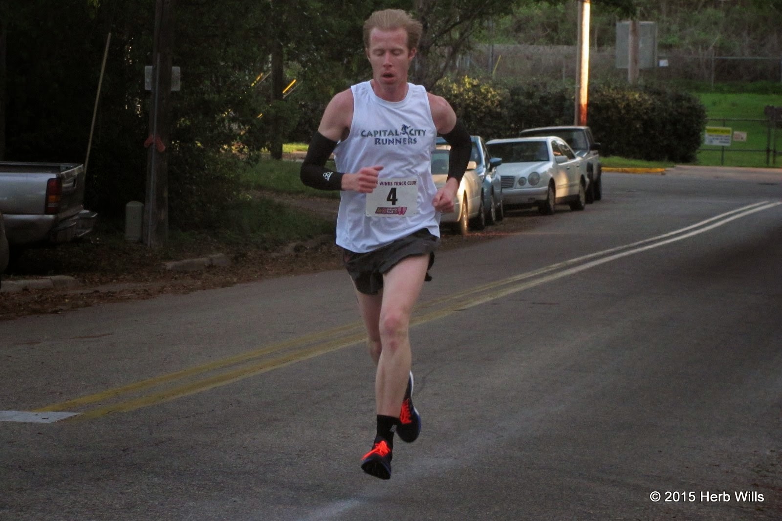 Stephen Cox (1st, 32:59) climbs a hill in the Myers Park neighborhood during Gulf Winds Track Club's 40th annual Springtime Road Race 10K Stephen Cox