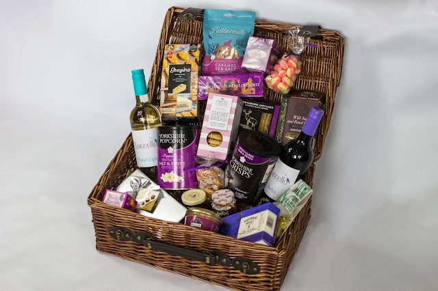 An open luxury wicker hamper from Prestige Hampers with all the contents displayed