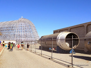 The metal skeletal structure of Hangar One with a star on top of the building.