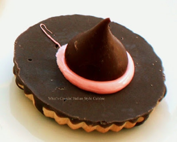 these are easy witches hats made from a dollar store fudge striped cookies into a witch hat with a Hershey's kiss on top in the middle