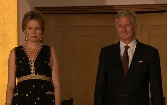 Queen Mathilde at Queen Elisabeth Piano Competition. Queen Mathilde wears Diane Von Furstenberg - DVF Vivanette Embroidered Tulle Goddess Gown. A Bag with a Story Clutch, TIKLI JEWELRY Gold Drop Earrings and Bracelet