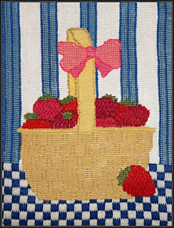 Needlepoint still life of a basket of strawberries