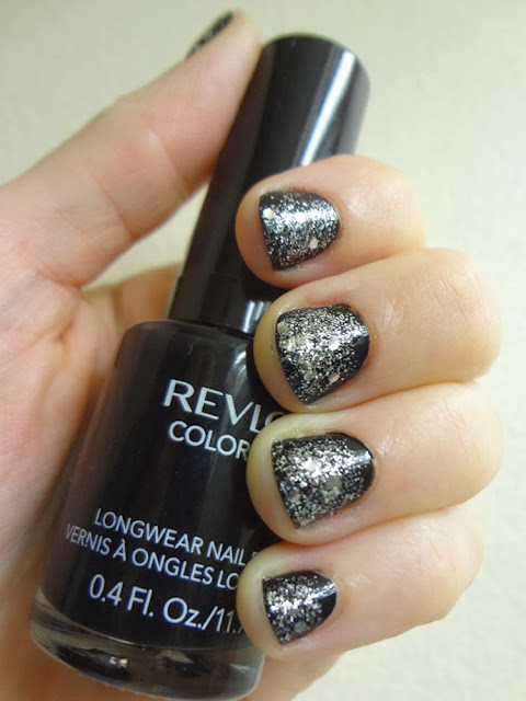 Black nail polish with silver glitter, perfect for New Year's Eve!