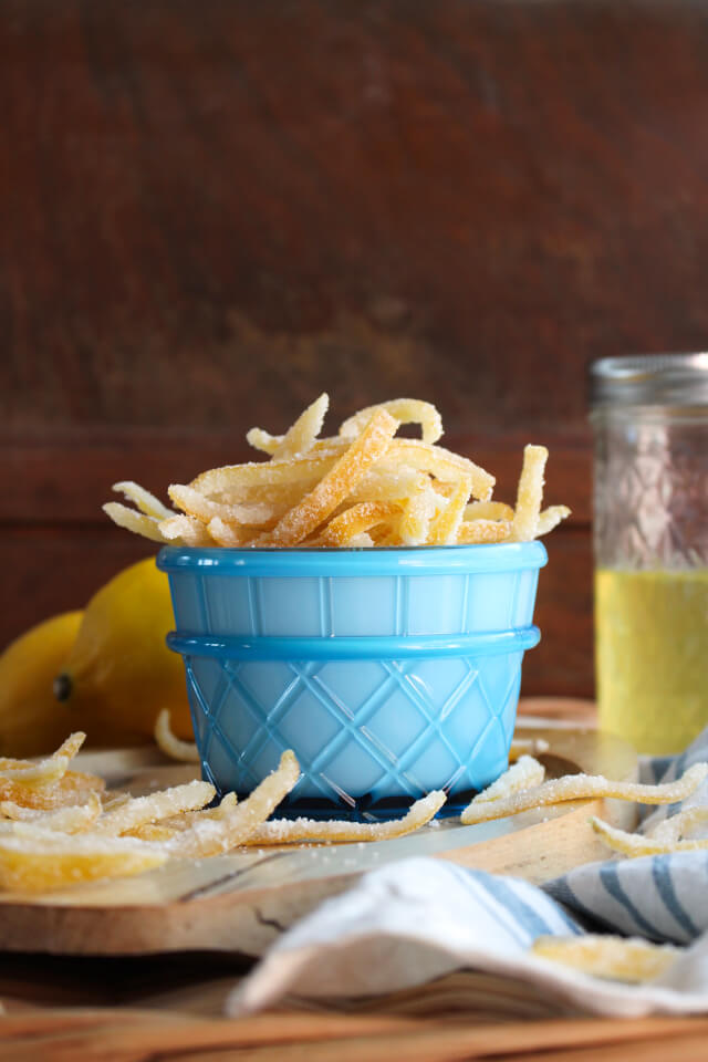 Candied Lemon Peel in a blue cup with a brown background.