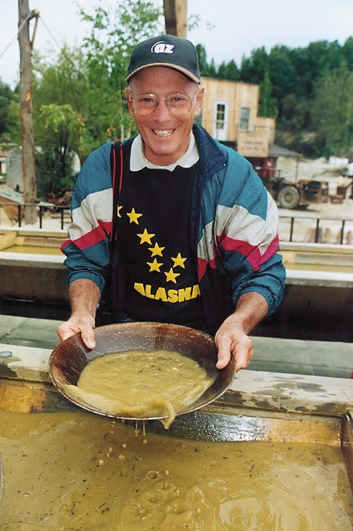 Tourist in Fairbanks Alaska tries panning for gold. Trying his hand at gold panning in Alaska.
