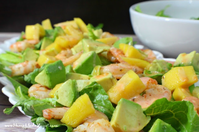 An easy and quick meal that can easily become a favorite. A quick fix recipe for shrimp, layered with mango and avocado on a bed of lettuce and drizzled with a caesar dressing and buffalo sauce mix.