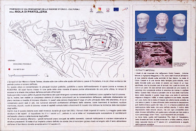 A sign explaining the Acropolis of Pantelleria (also called the Acropolis of San Marco and Santa Teresa). The acropolis is where three Roman marble heads were found dating from 100 AD. A sign explaining the Acropolis of Pantelleria (also called the Acropolis of San Marco and Santa Teresa). The acropolis is where three Roman marble heads were found dating from 100 AD.