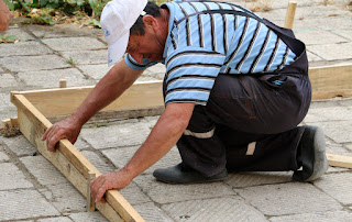 Bekir makes the wooden forms, careful to get them level Bekir makes the wooden forms, careful to get them level