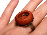 pumpkin and gold colored adjustable button ring