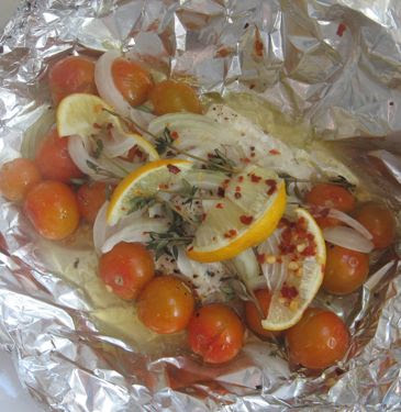 Baked flounder packets with cherry tomatoes, onion, and lemon