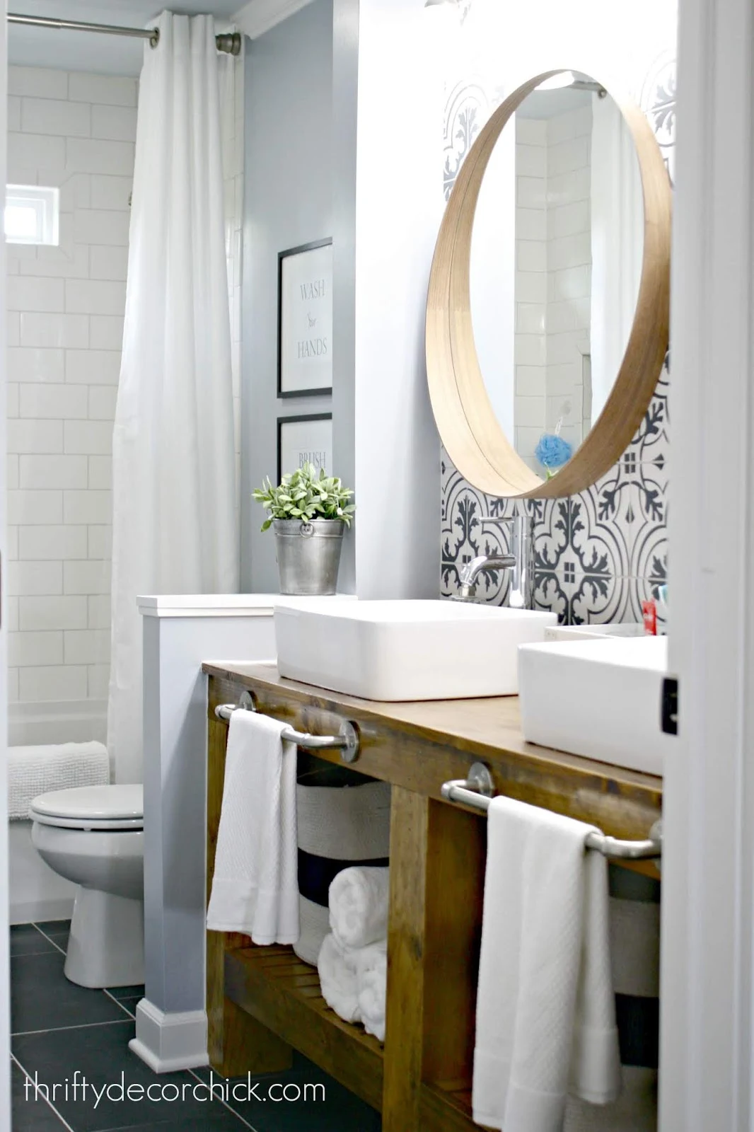 DIY bathroom vanity with black and white tile wall